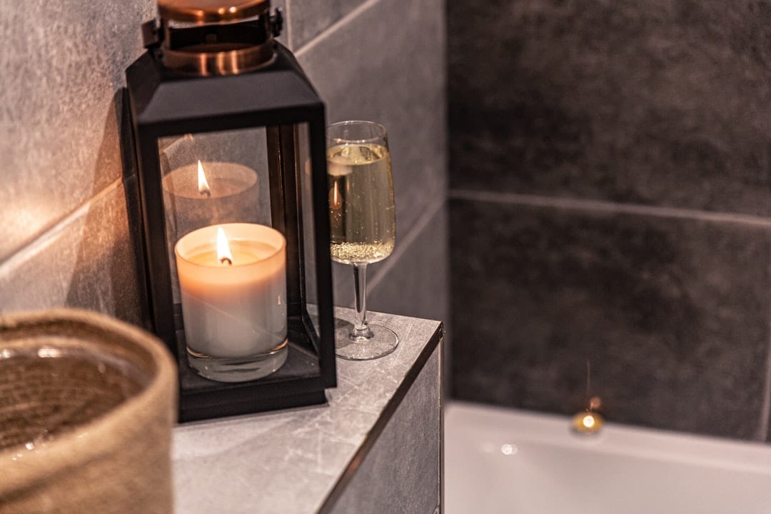 Elegant candle in luxury hotel bathroom setting