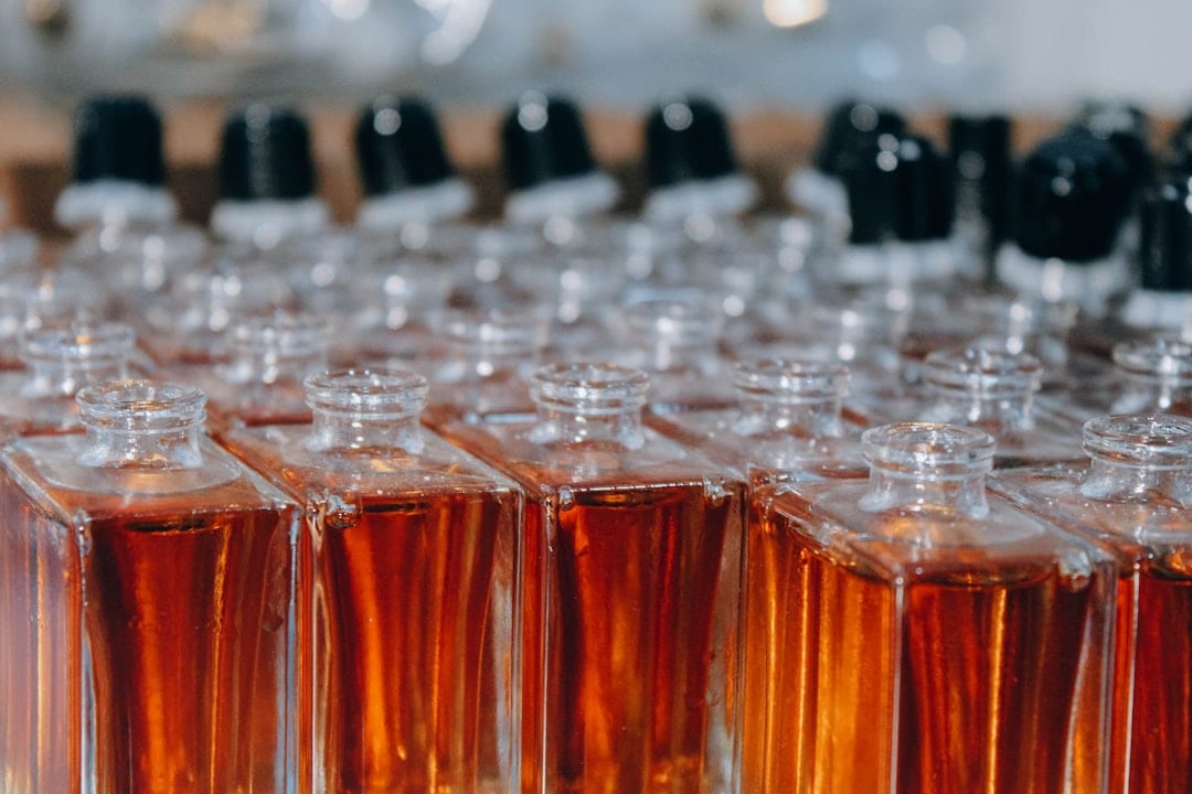 Perfumer at work with fragrance bottles and testing lab